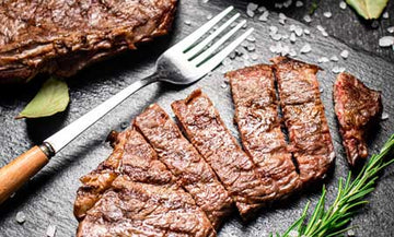 Sliced grilled lamb steak with fresh rosemary