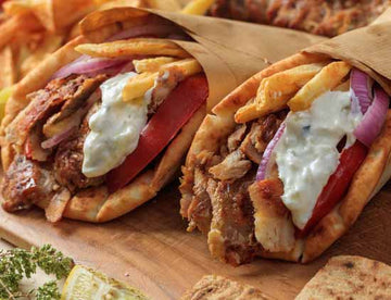 Grilled sirloin beef pita with cucumber sauce, onion and tomato