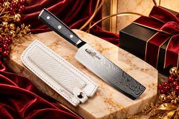 Chef Supply Co. Damascus cleaver with a black honeycomb handle and white leather sheath, styled on cream marble with burgundy velvet and gold accents for personalised corporate gifting.