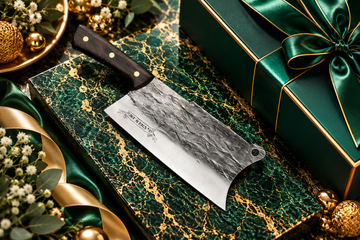 Premium cleaver on emerald green marble with gold veining and luxury gift packaging for employee engagement events.