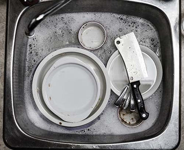 Chef knife and cleaver in a kitchen sink
