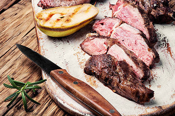 Sliced grilled steak with fresh rosemary